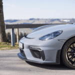 Side of the front Porsche Cayman GT4 on Lake Constance