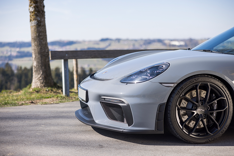 Side of the front Porsche Cayman GT4 on Lake Constance
